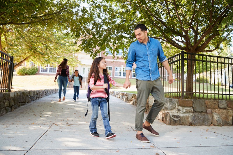 father collecting daughter at the end of school